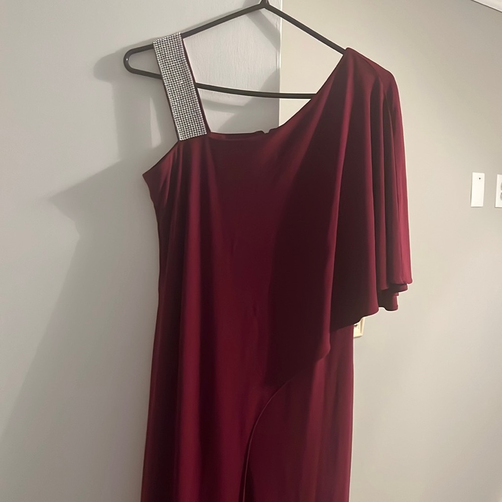 It’s a pantsuit with a rhinestone shoulder. It’s like a red purple